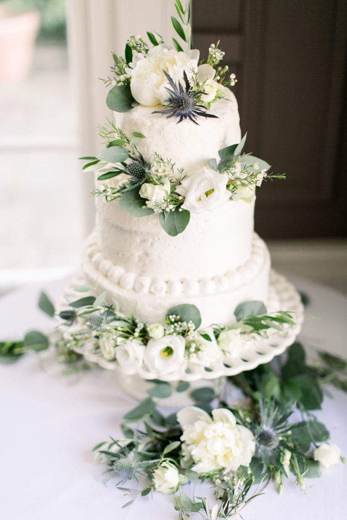 Green and white flowers on a wedding cake