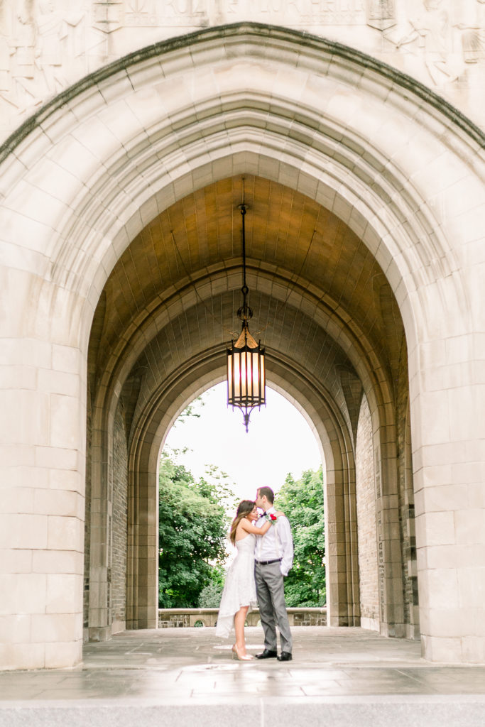Couple kissing under stone archway