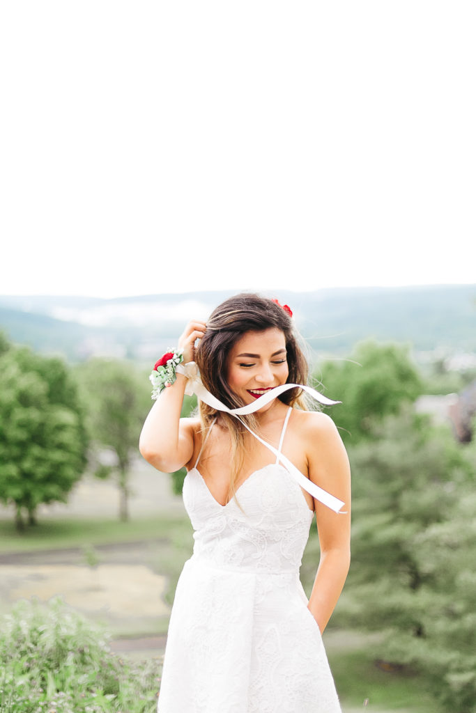 Bride laughing with ribbons blowing in front of her face