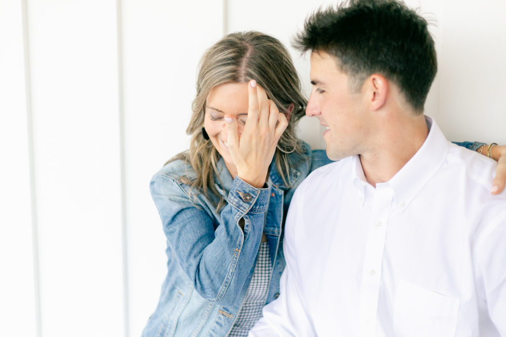 A couple laughing during an engagement session at The Lake House on Canandaigua.