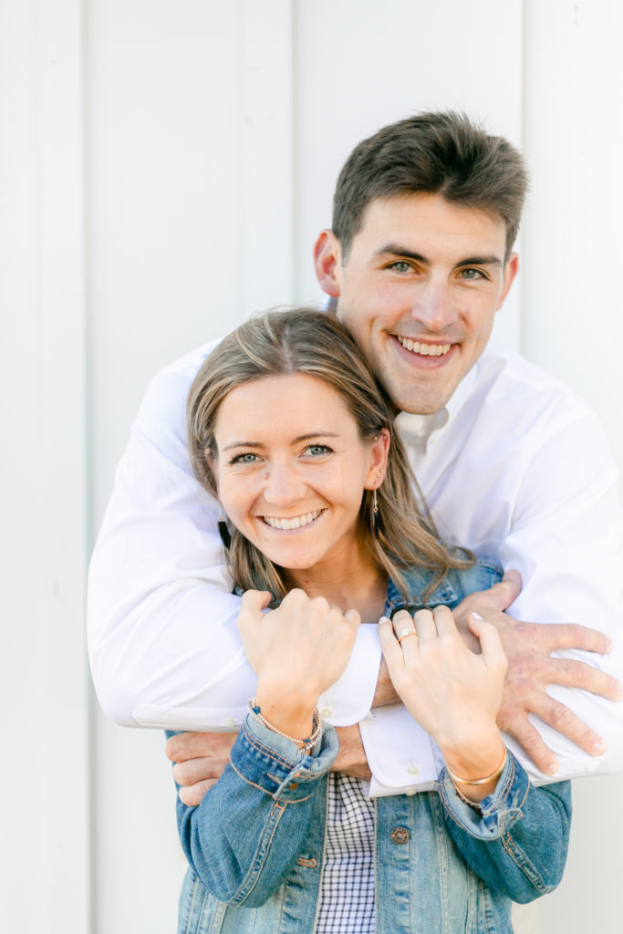 An engaged couple embracing during a portrait session at The Lake House on Canandaigua.